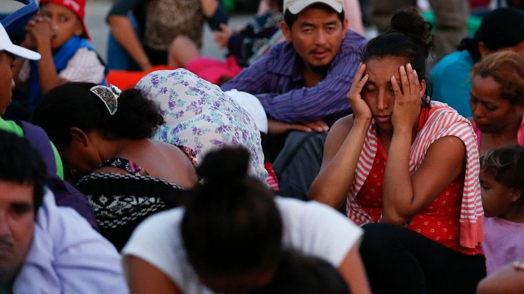 Exhausted migrants wait as a thousands-strong caravan of Central Americans continues its slow journey toward the US border.