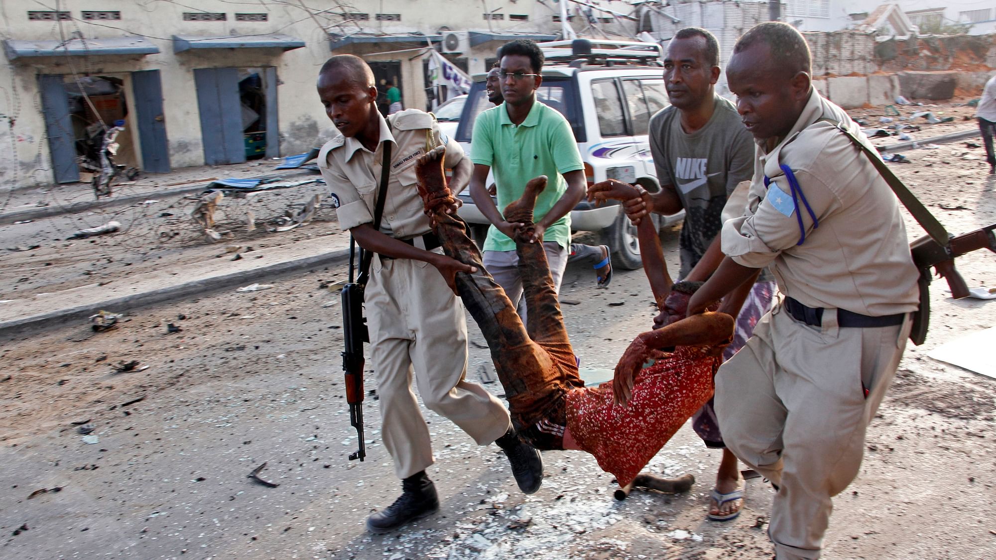Rescuers carry a man severely injured in the car bombs that went off in Mogadishu on Friday, 9 November.