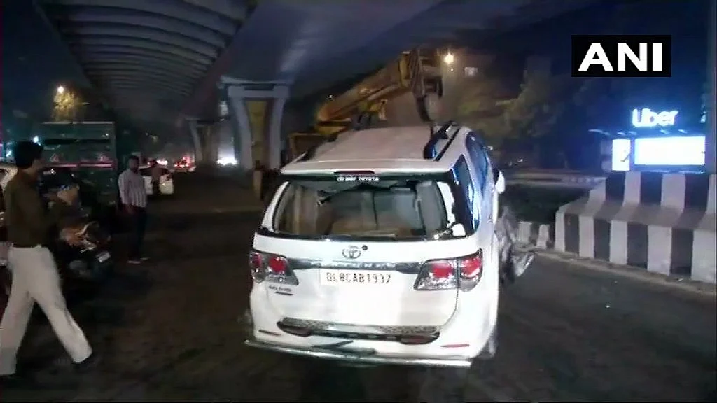The car being taken away by a crane.