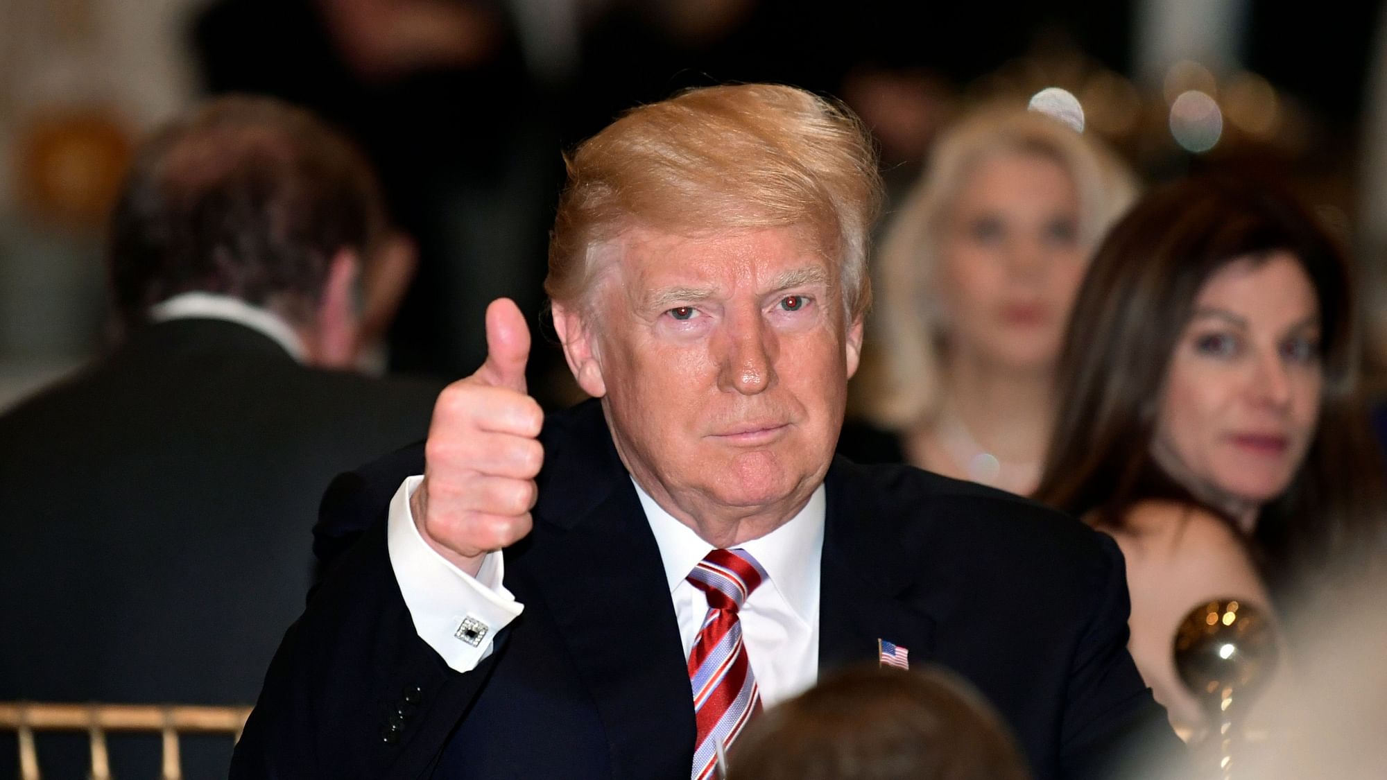 President Donald Trump gives a thumbs-up as he has Thanksgiving Day dinner at his Mar-a-Lago estate in Palm Beach, Florida, Thursday, November 22, 2018.
