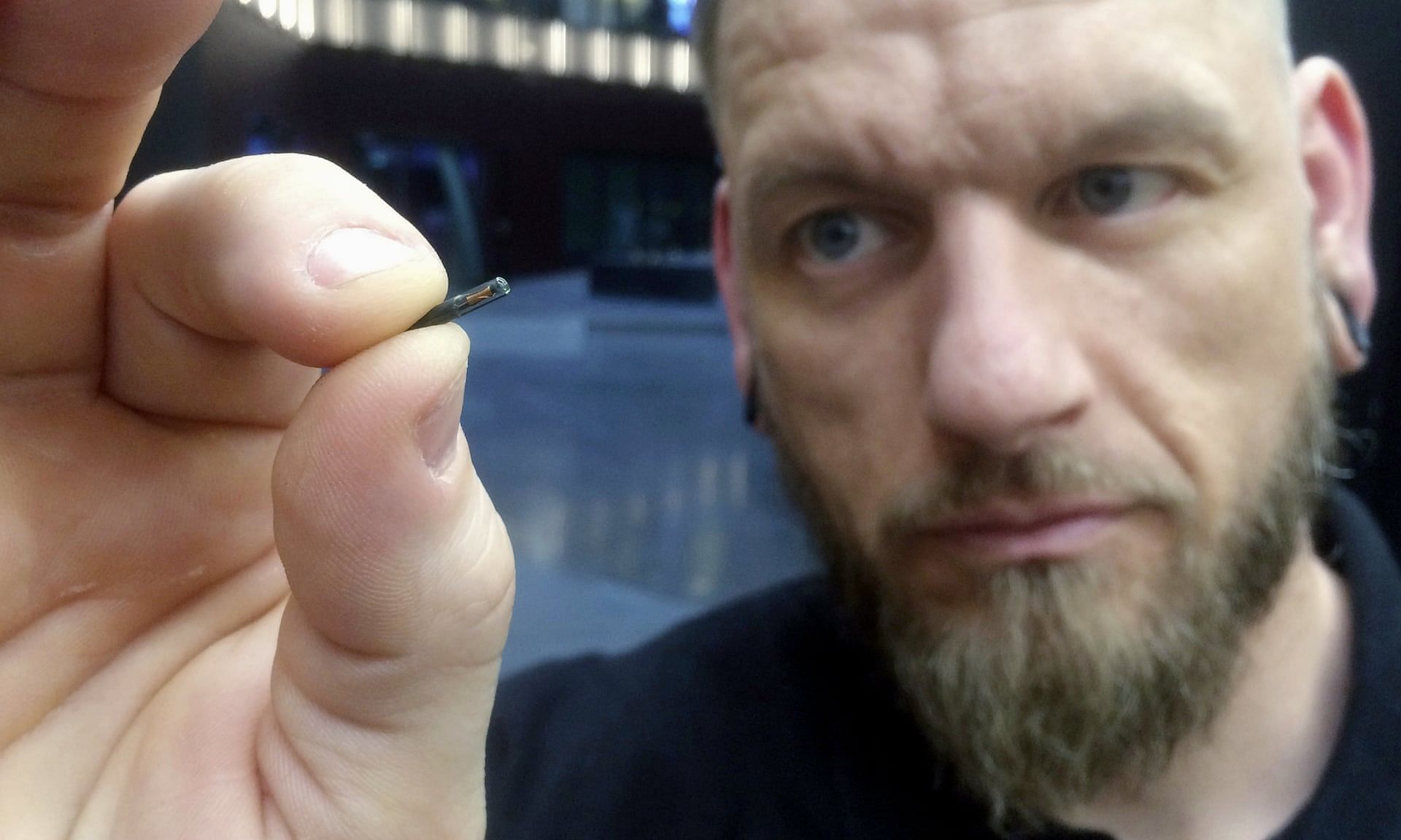 Jowan Osterlund from Biohax holds a microchip.&nbsp;