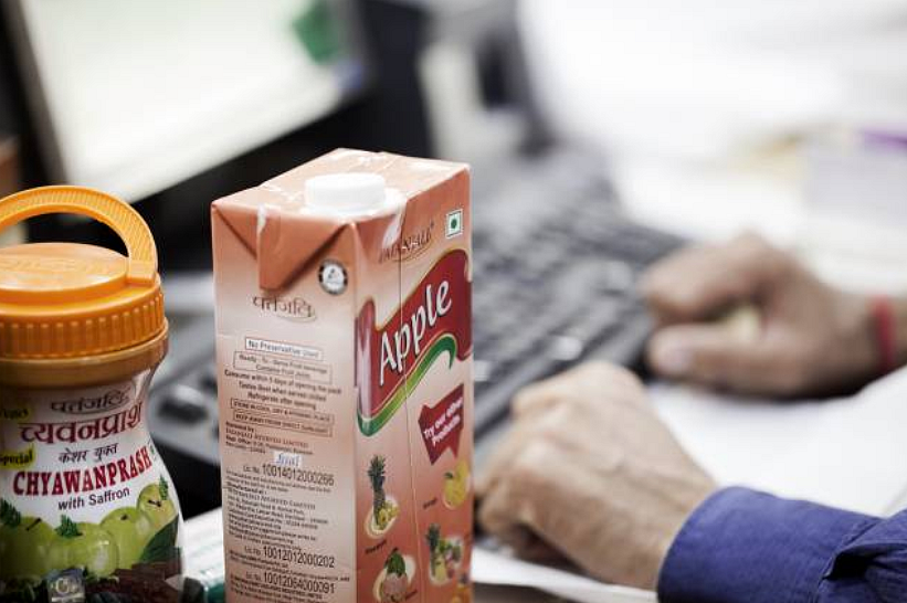 A container of chyawanprash and a carton of apple juice sit on a counter at a Patanjali Ayurved Ltd. store in New Delhi. 