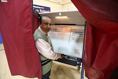 New Jersey: A man casts his vote during the U.S. Midterm Elections at a polling booth in New Jersey, United States, on Nov 6, 2018. (Photo: Mohammed Jaffer/IANS)