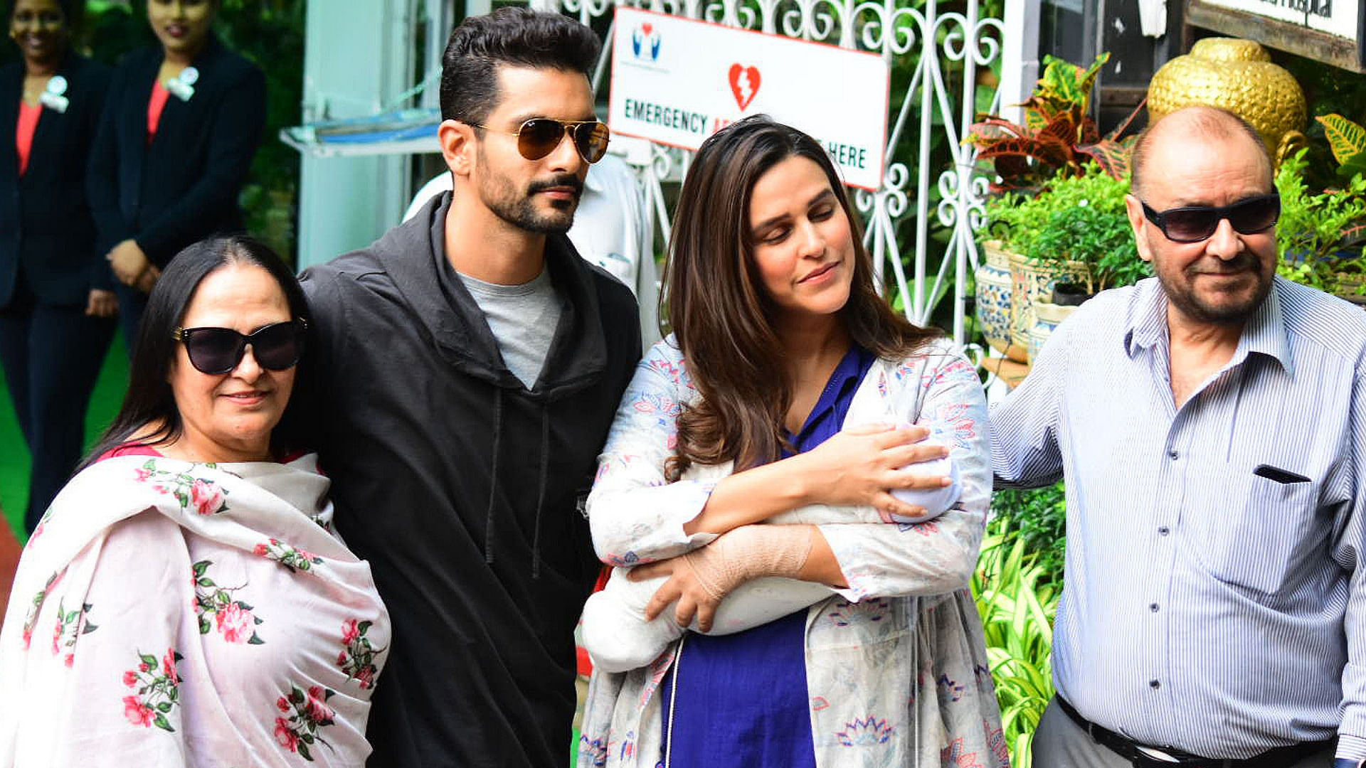 Neha Dhupia and Angad Bedi leave a Mumbai hospital with their baby Mehr.