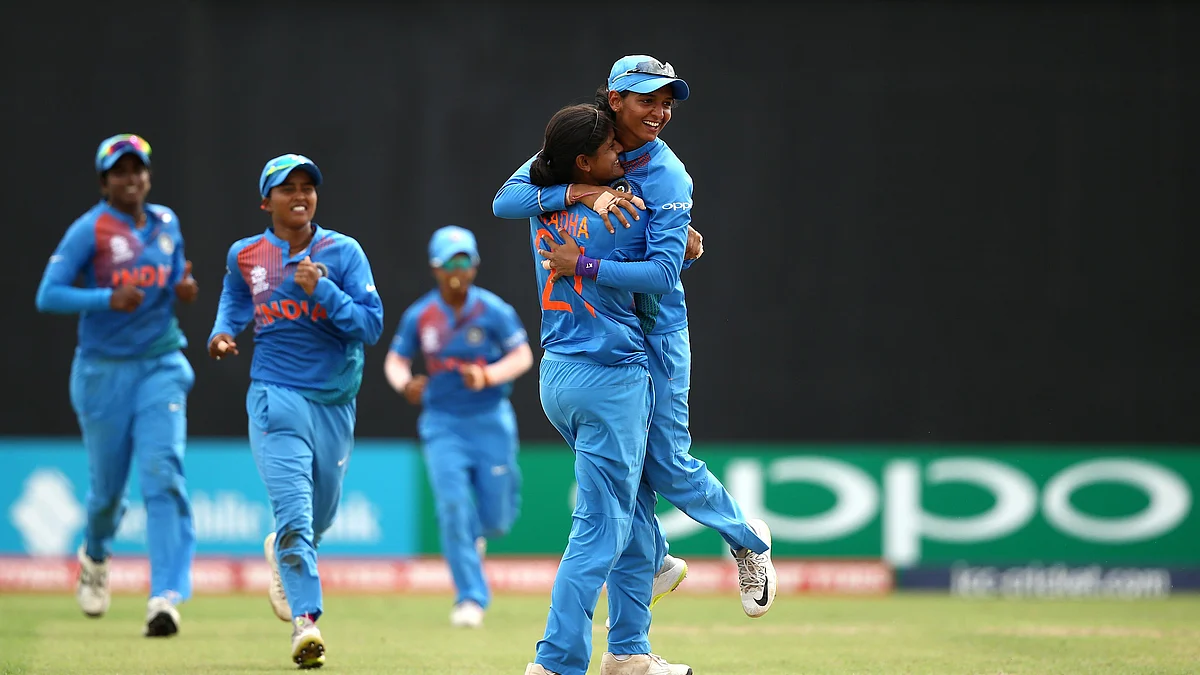 Radha Yadav celebrates a wicket with her teammates.