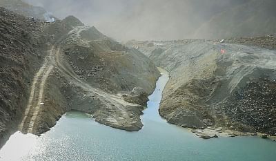 CHANGDU, Nov. 13, 2018 (Xinhua) -- Aerial photo taken on Nov. 13, 2018 shows water of a landslide-caused barrier lake on the Jinsha River flows through a drainage channel in the border area between Sichuan Province and Tibet Autonomous Region in southwest China. A drainage channel constructed by disaster relief staff successfully resumed the flow of Jinsha River, which had been blocked by a barrier lake formed following a landslide that hit the area on Nov. 3.    (Xinhua/Feng Yunhu/IANS)