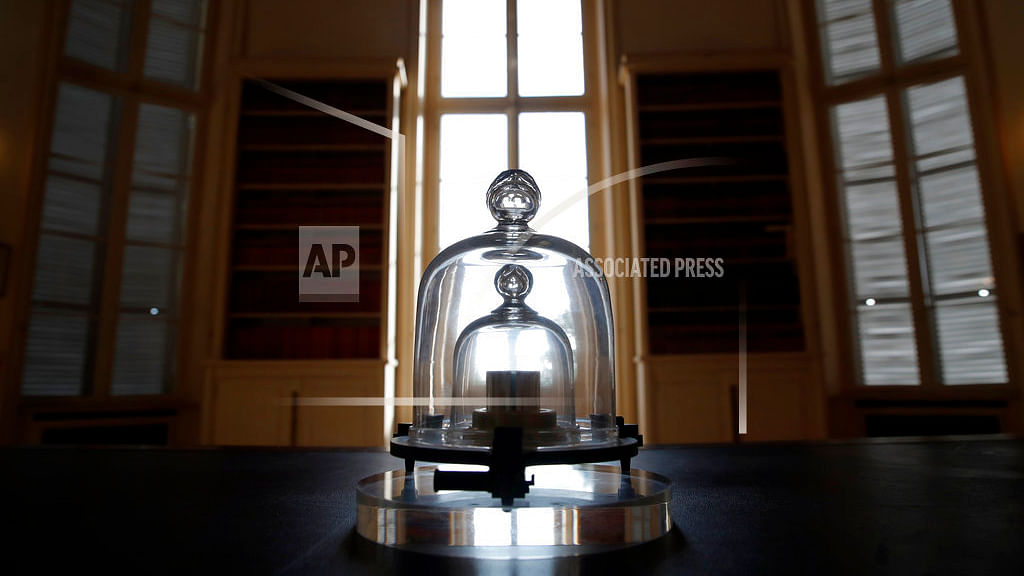In this photo taken Wednesday, 17 October 2018, a replica of the International Prototype Kilogram is pictured at the International Bureau of Weights and Measures, in Sevres, near Paris. The golf ball-sized metal cylinder at the heart of the world’s system for measuring mass is heading into retirement.