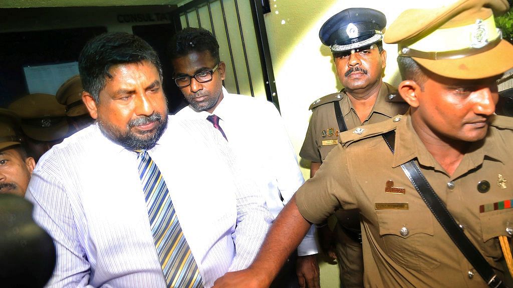 Chief of Defense Staff Admiral Ravindra Wijegunaratne is taken away by police officers from a court in Colombo, Sri Lanka.