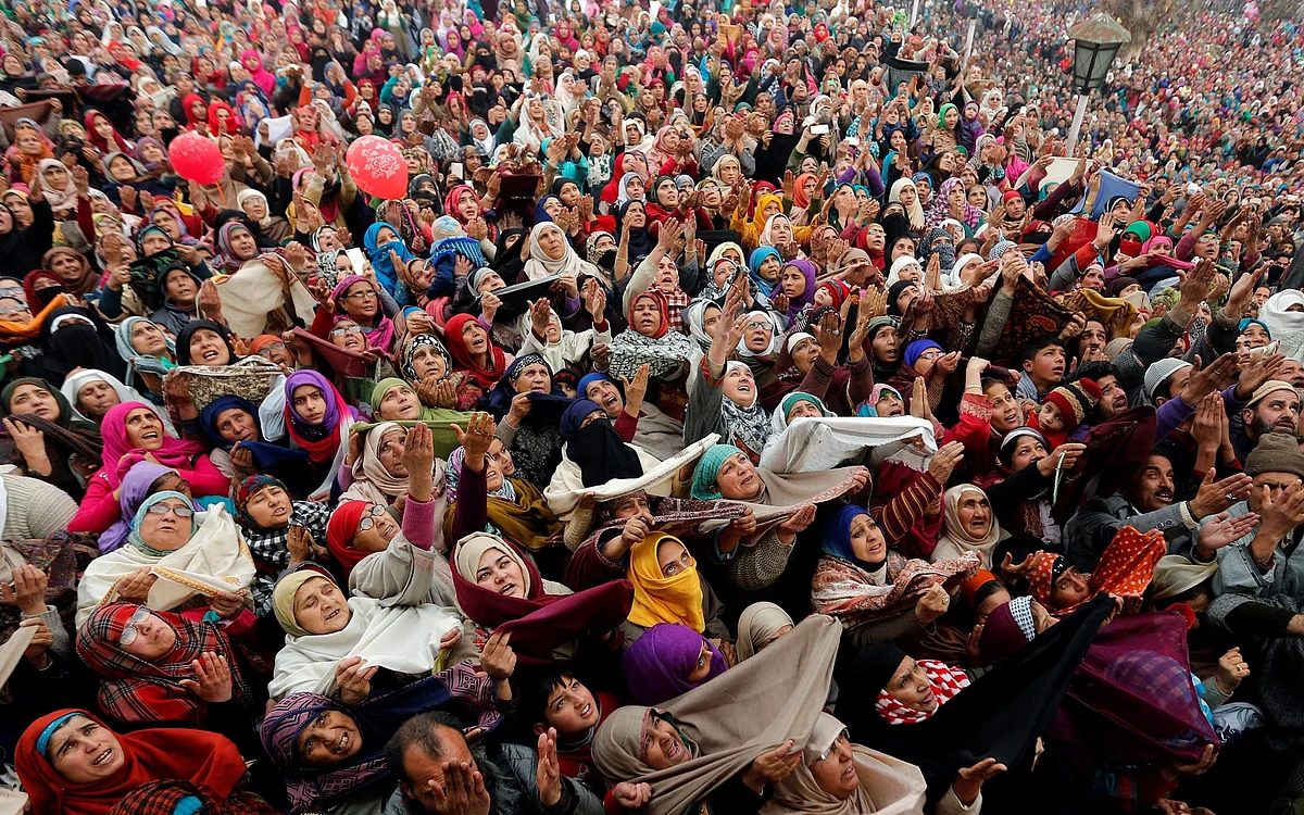 People react upon seeing a relic believed to be a hair from the beard of Prophet Mohammed, on the festival of Eid-e-Milad-ul-Nabi at the Hazratbal shrine in Srinagar.