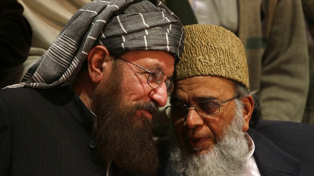  In this February 2014 photo, Pakistani religious cleric Samiul Haq (left) talks with Syed Munawar Hasan, the head of the Jamaat-e-Islami party, during a press conference in Lahore.