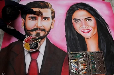 Amritsar: A fan gives finishing touches to the portrait of actors Ranveer Singh and Deepika Padukone, who will tie the knot in a ceremony which will take place over two days on November 14-15 in Italy