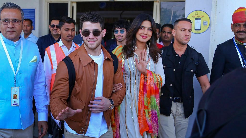 Priyanka and Nick wave to the paps as they arrive in Jodhpur.&nbsp;