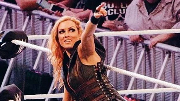 Becky Lynch points to the crowd while entering the ring.