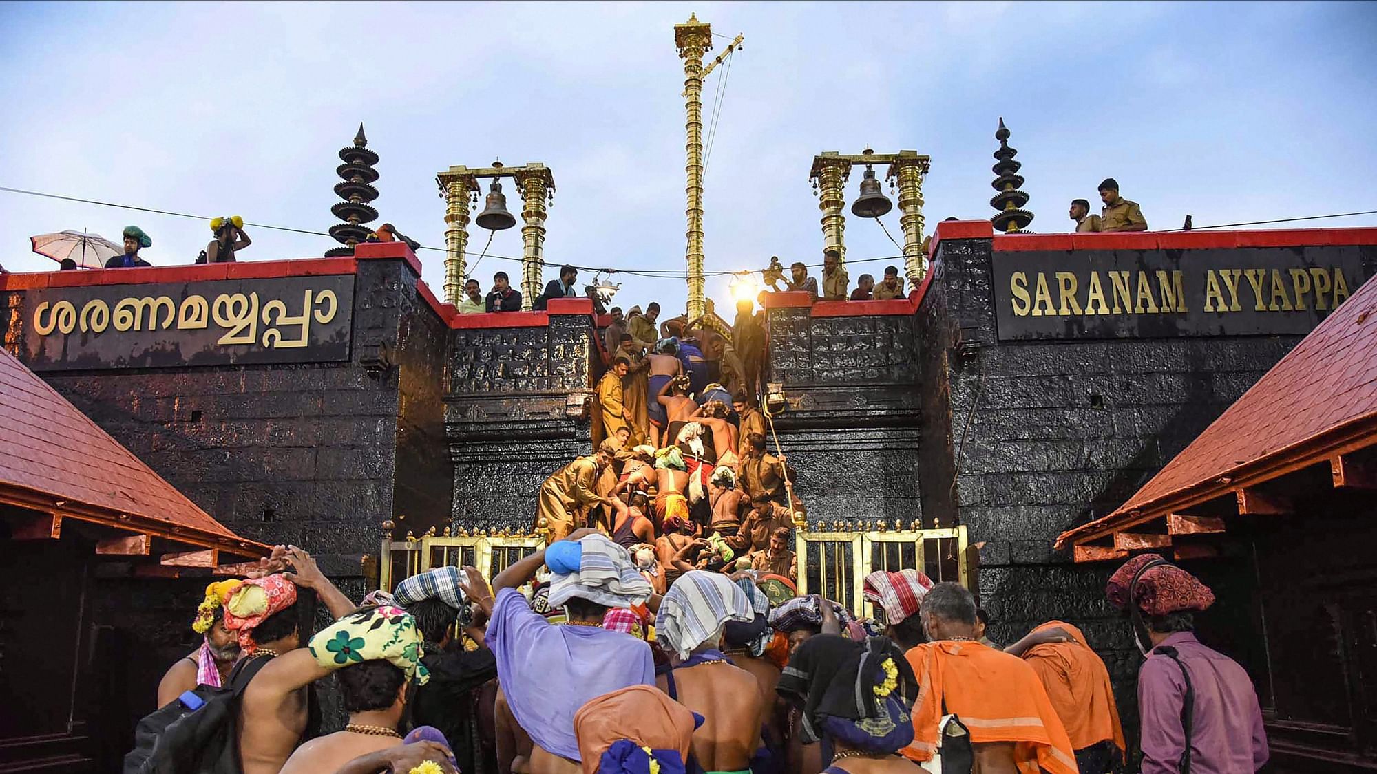 Devotees enter Sabarimala temple after it opened on 16 November.