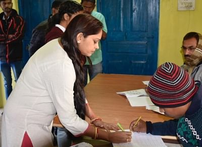 Narayanpur: A woman signs a register before casting her vote during the 1st phase of Chhattisgarh Assembly Elections at a polling booth in Narayanpur on Nov 12, 2018. (Photo: IANS/PIB)