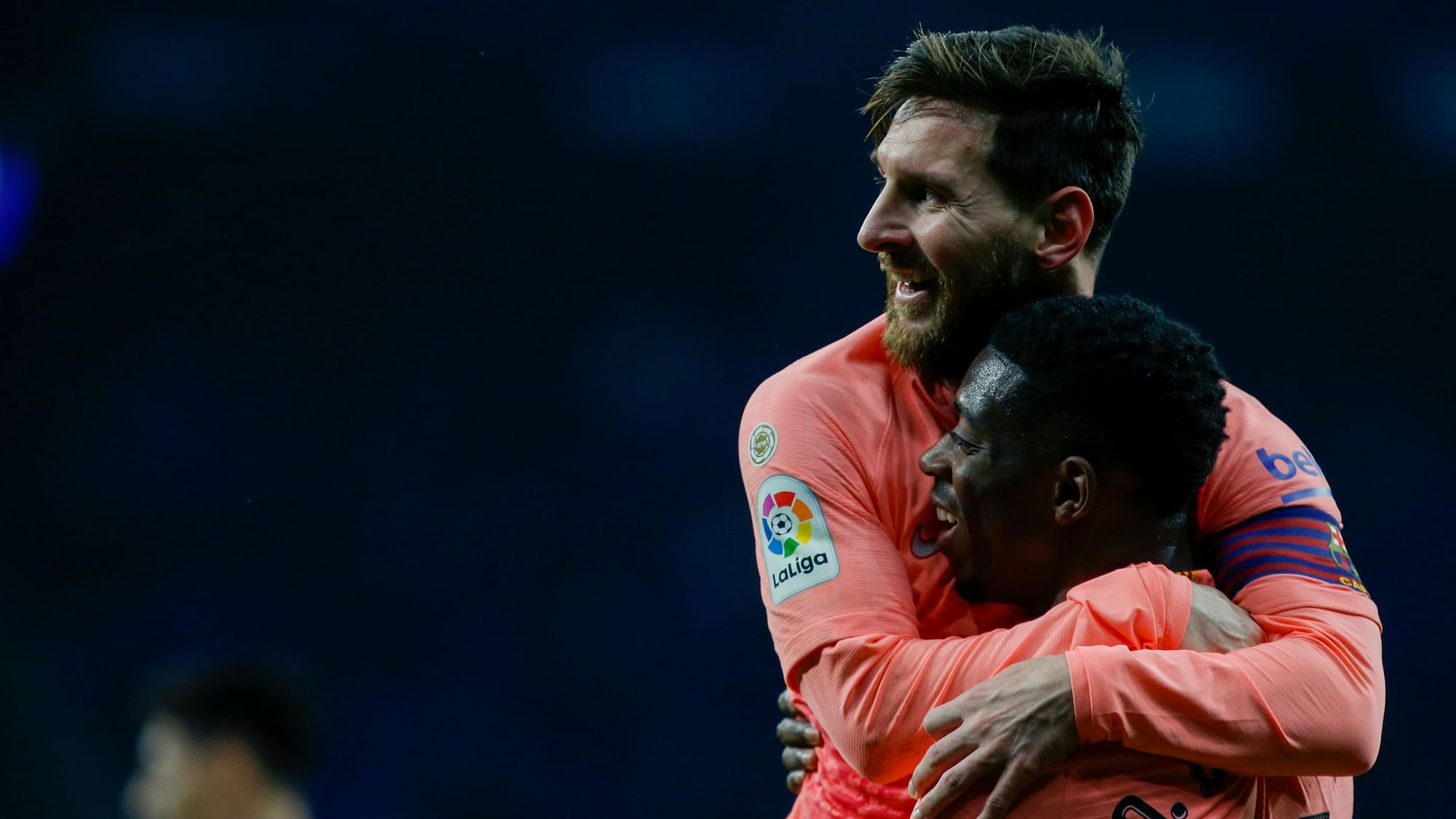 FC Barcelona’s Lionel Messi celebrates with teammate Ousmane Dembele during the Spanish La Liga soccer match between Espanyol and FC Barcelona.