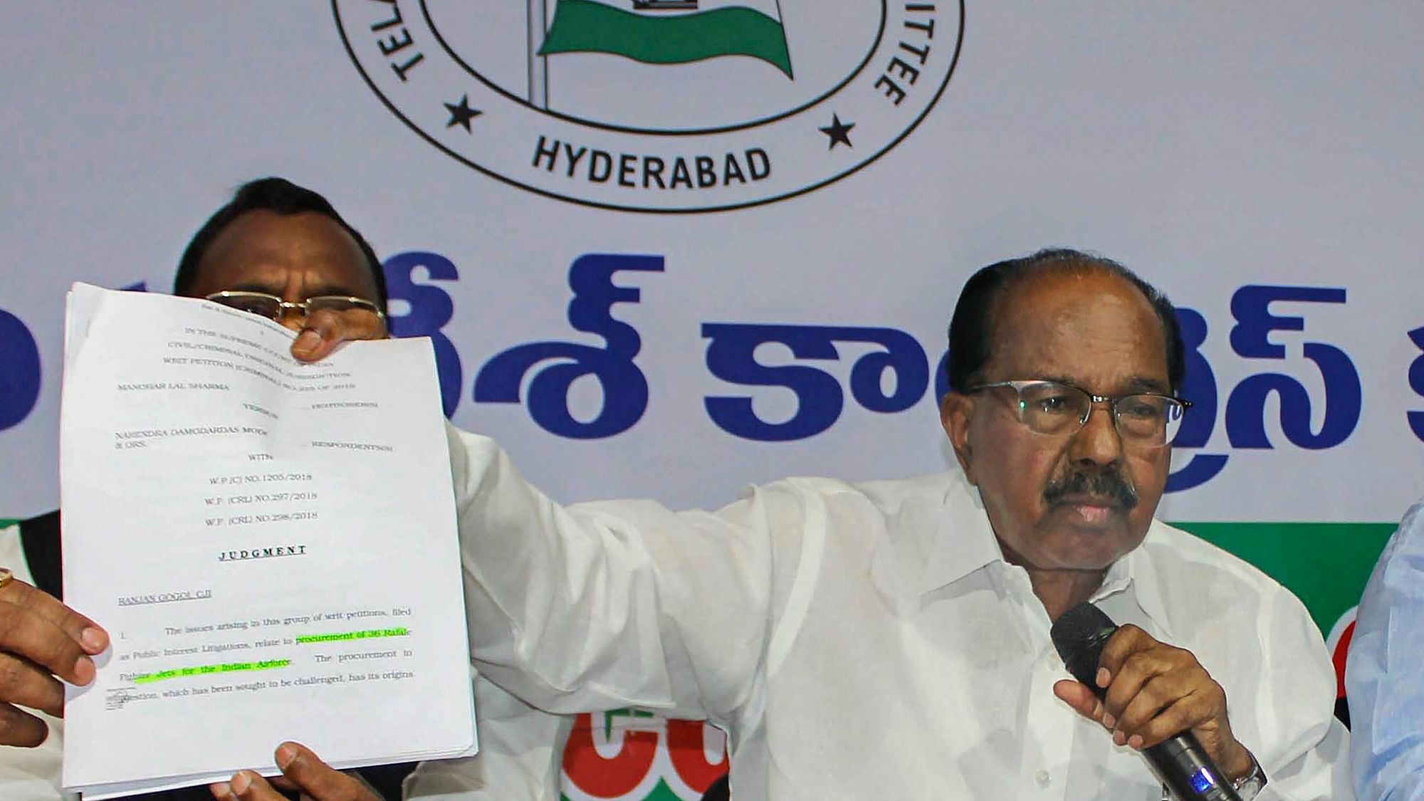 Parliamentary Standing Committee chairperson Veerappa Moily shows the copy of the Supreme Court order regarding Rafale Deal during a press conference in Hyderabad on 20 December.