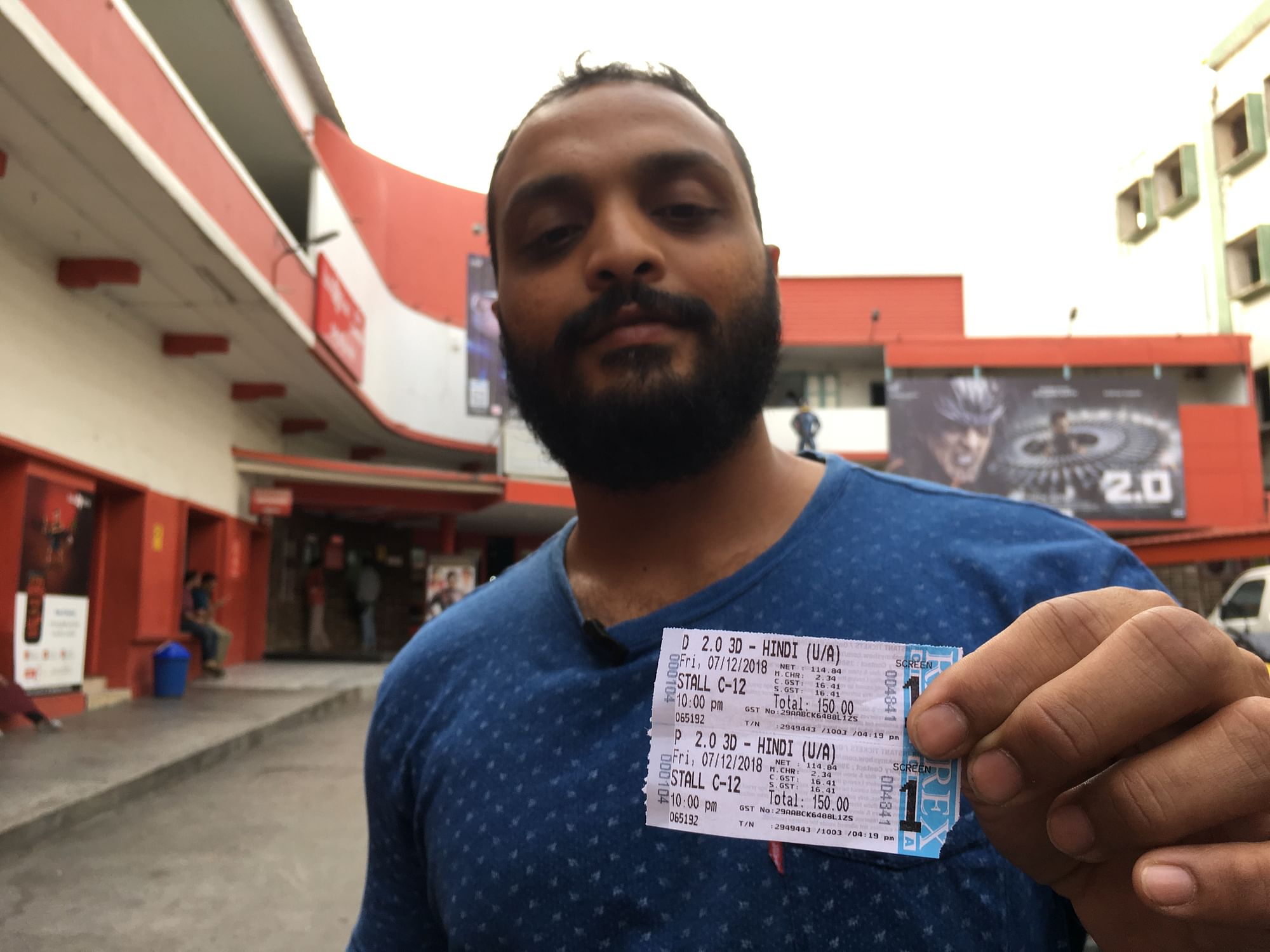 A movie-goer shows off his Rs 150 priced ticket at Rex theatre on Brigade Road.
