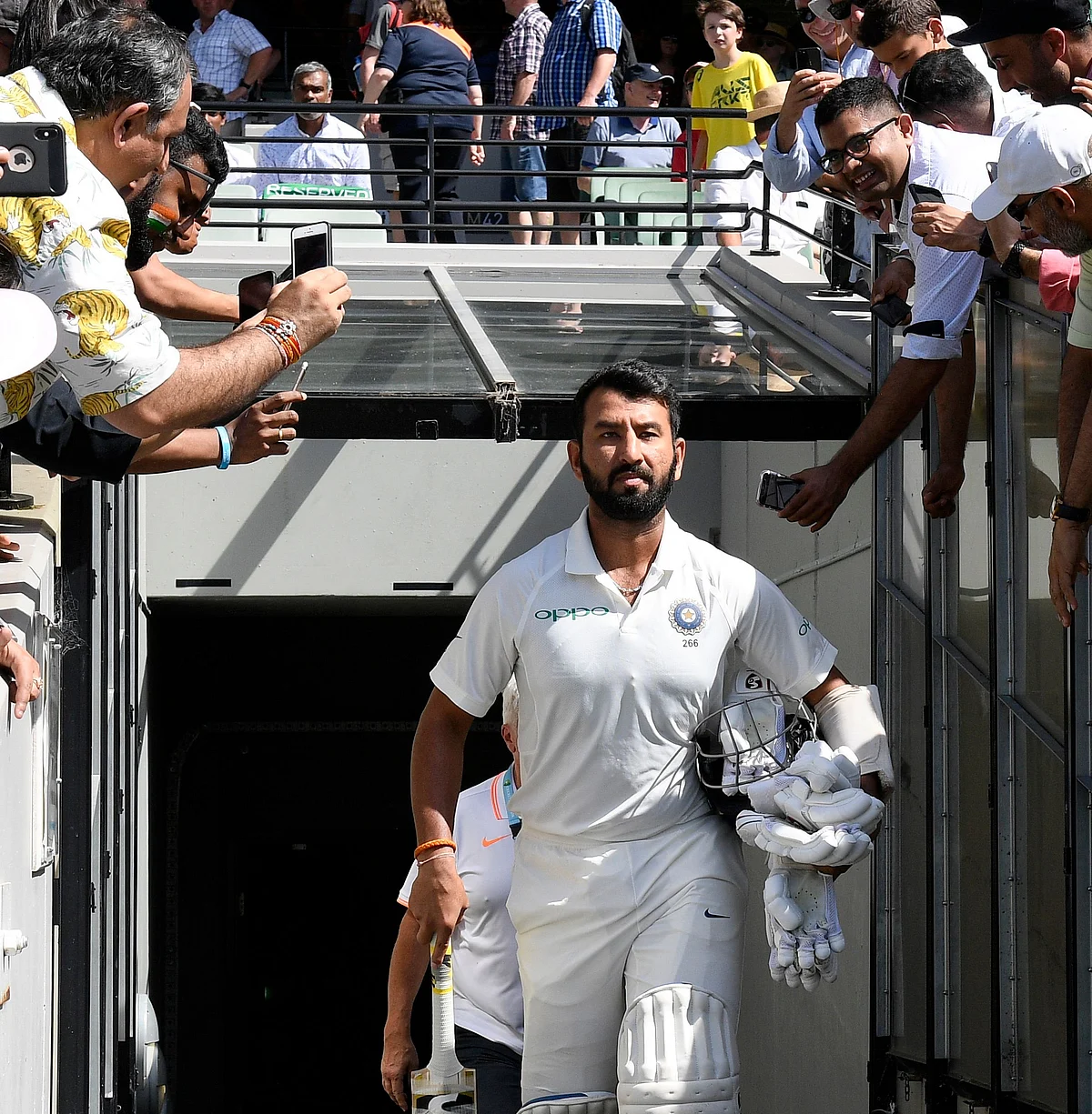 India’s India’s Cheteshwar Pujara, enters the field before play on day two of the third cricket test between India and Australia in Melbourne.