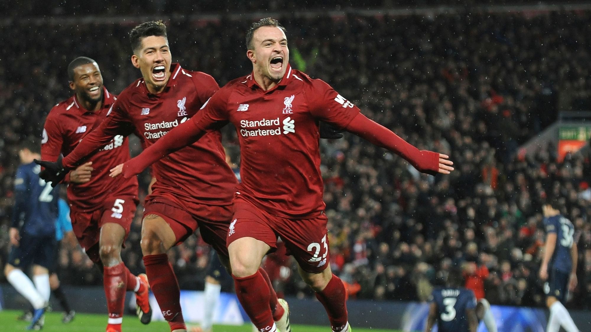 Liverpool’s Xherdan Shaqiri, right, celebrates after scoring his side’s third goal during the English Premier League soccer match between Liverpool and Manchester United.