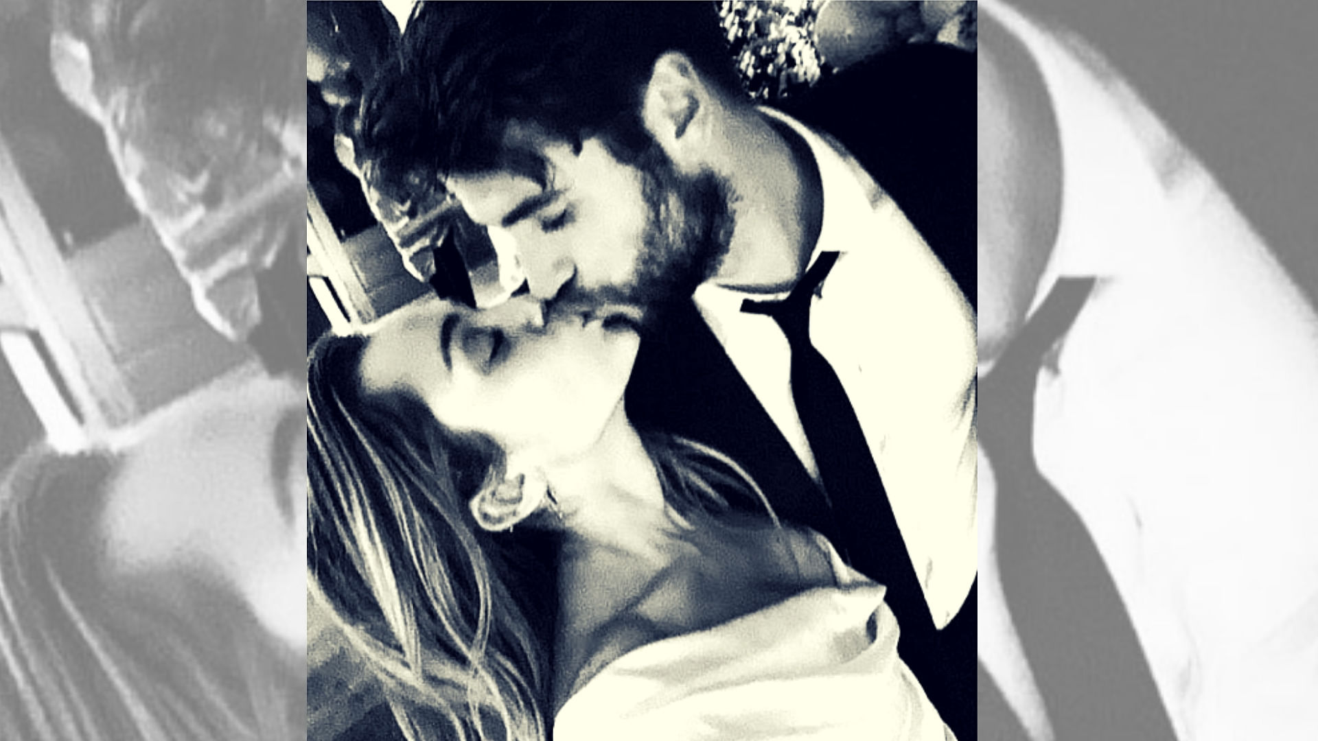 Miley Cyrus and Liam Hemsworth share a kiss.&nbsp;
