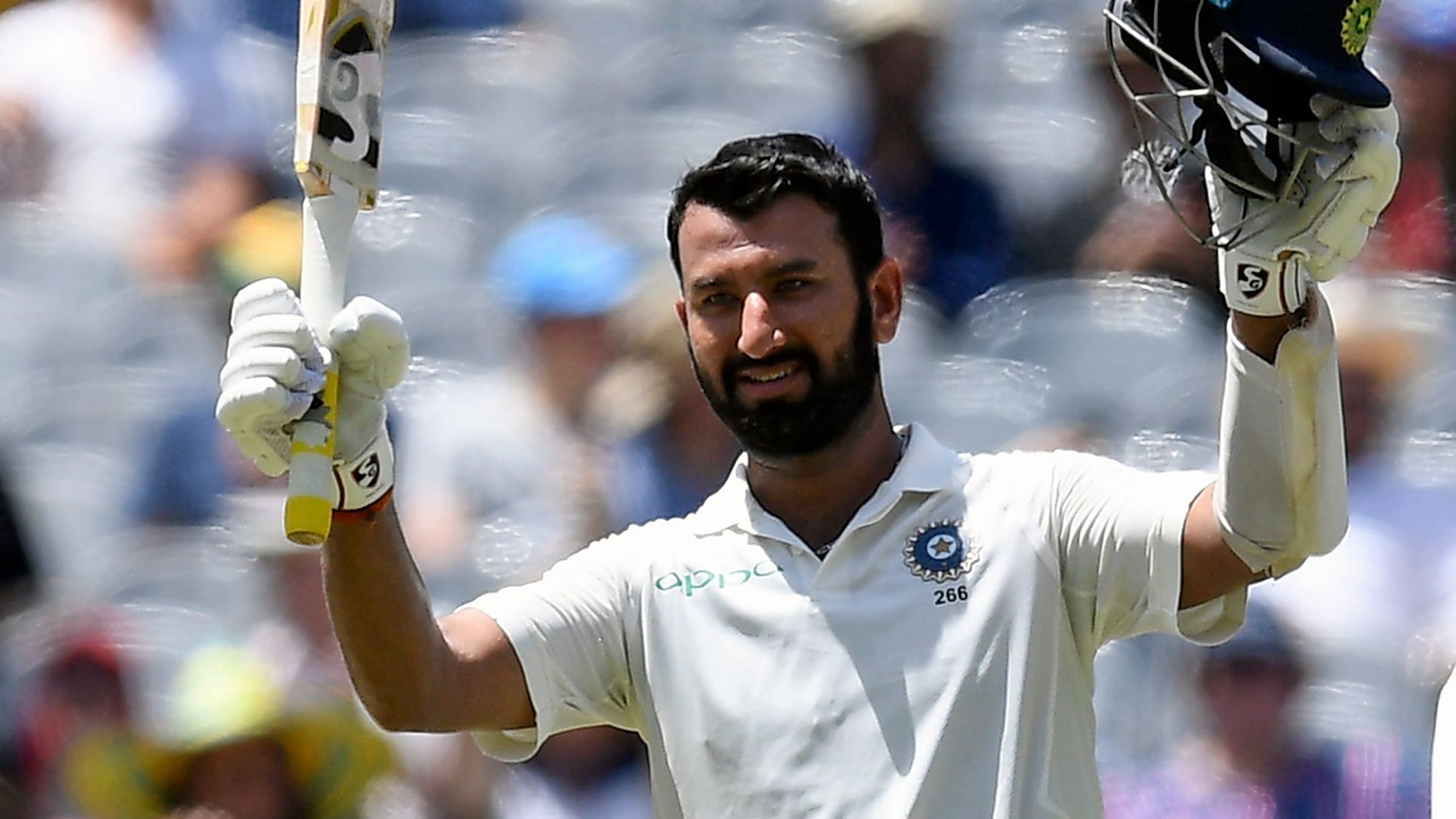  India’s Cheteshwar celebrates scoring a century during day two of the third cricket test between India and Australia in Melbourne.