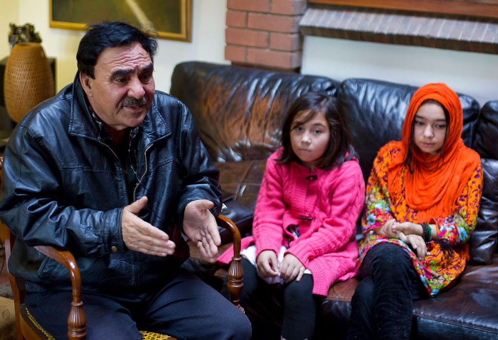 In this 29 November 2018 photo, Mir Aman speaks to The Associated Press with his daughters Shahnaz (right) and Shakeela, in Islamabad, Pakistan. &nbsp;