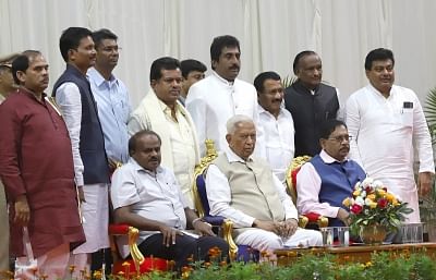 Bengaluru: Karnataka Governor Vajubhai Vala, Chief Minister H.D. Kumaraswamy and Deputy Chief Minister G. Parameshwara with the eight newly inducted ministers at a swearing-in ceremony at Raj Bhavan in Bengaluru on Dec 22, 2018. (Photo: IANS)