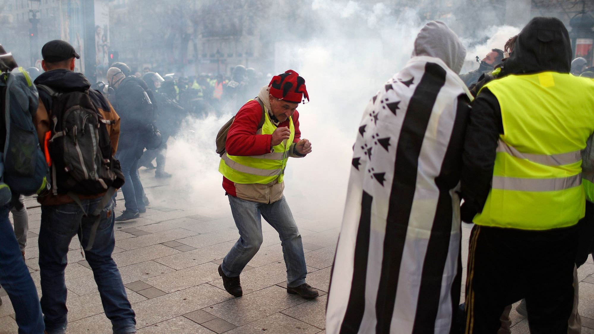 A teargas canister falls among demonstrators wearing yellow vests Saturday, 8 December, 2018 in Paris.&nbsp;