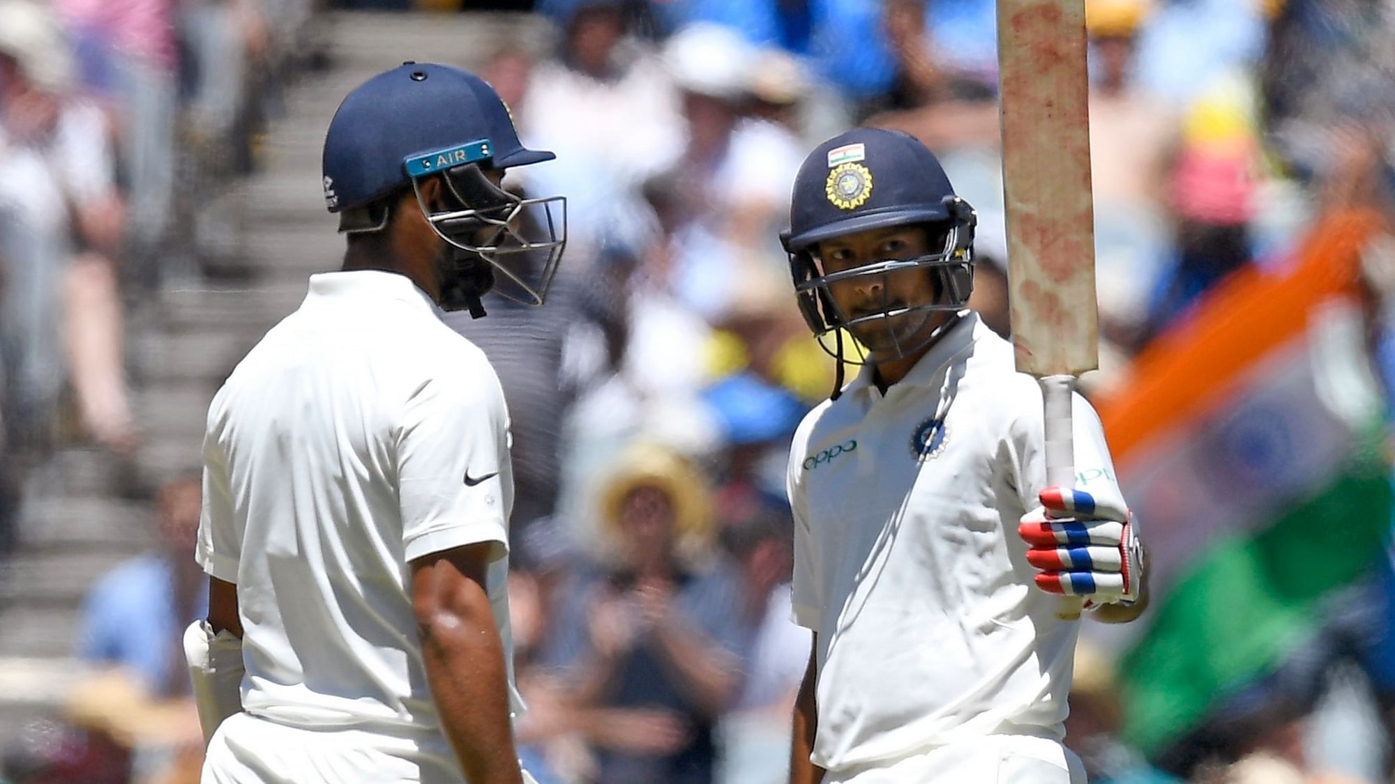 India’s Mayank Agarwal, right celebrates with team-mate, left Cheteshwar Pujara after scoring a half century on day one of the third cricket test between India and Australia in Melbourne, Australia, Wednesday, Dec. 26, 2018.&nbsp;