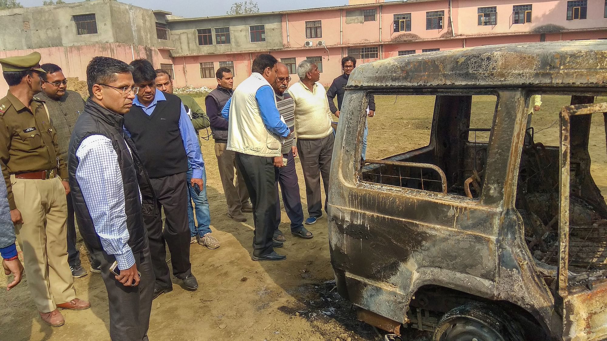 Policemen inspect vehicles set on fire by a mob on Thursday, 6 December, during a protest over the alleged illegal slaughter of cattle in Bulandshahr.
