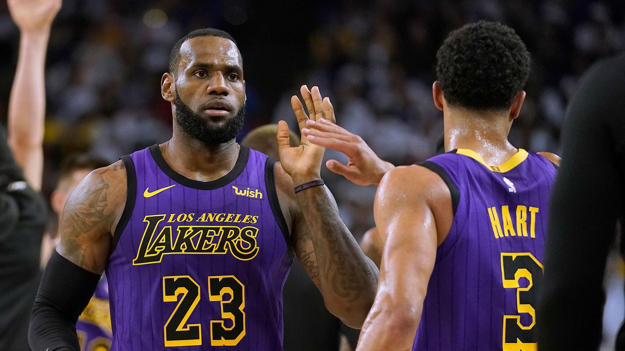 Los Angeles Lakers forward LeBron James (23) high-fives Josh Hart (3) at the end of the first half of the team’s NBA basketball game against the Golden State Warriors on Tuesday, Dec. 25, 2018, in Oakland, Calif.&nbsp;