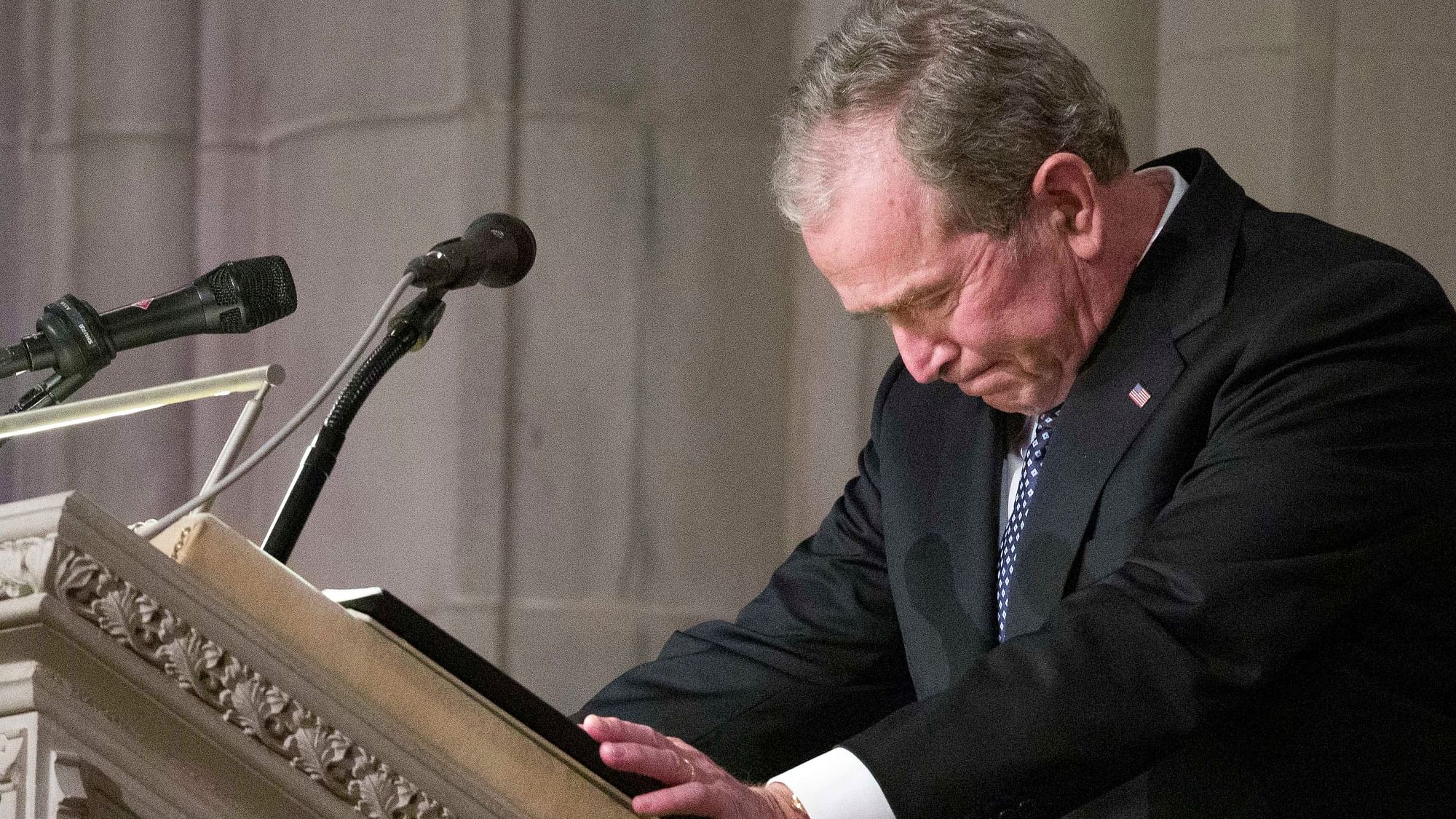 Former President George Bush becomes emotional as he speaks at the State Funeral for his father, former President George H.W. Bush, at the National Cathedral.