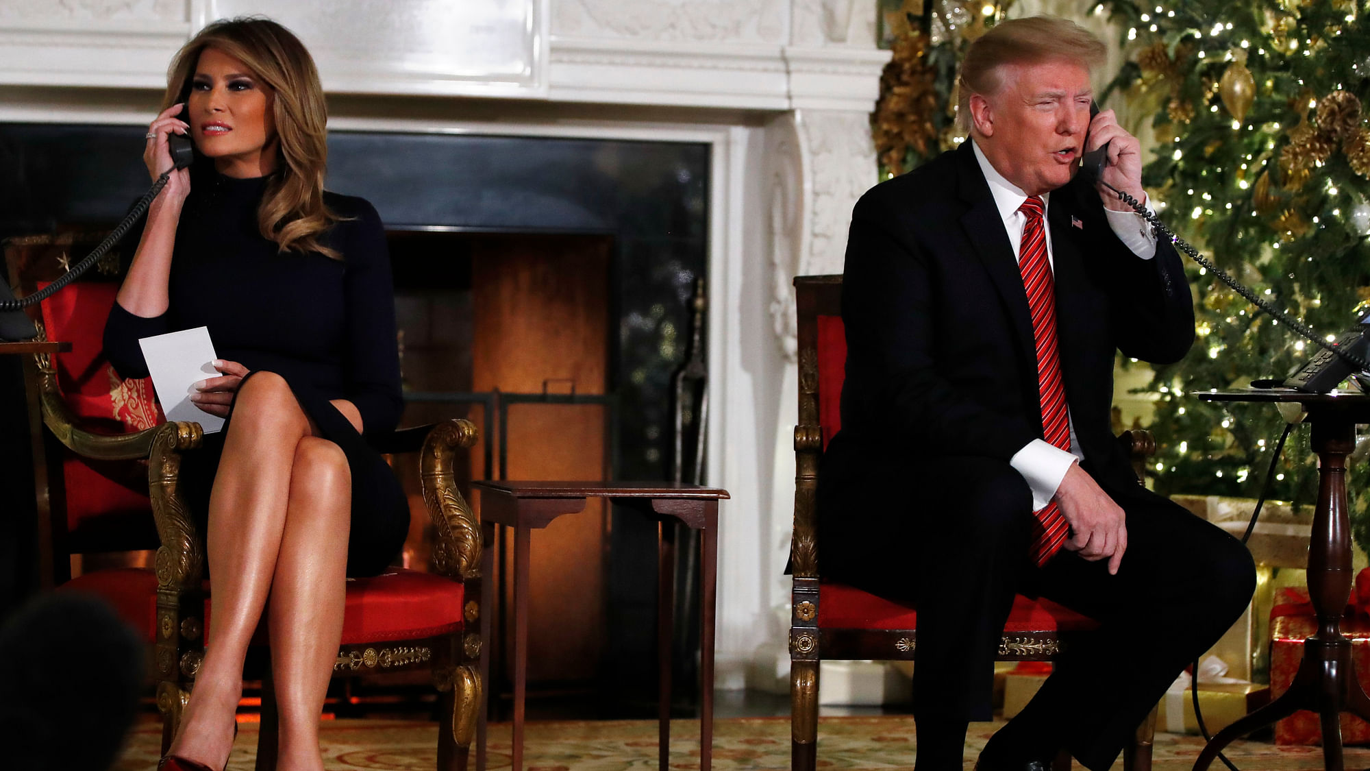 President Donald Trump and first lady Melania Trump both speak on the phone while sharing updates to track Santa’s movements from the North American Aerospace Defense Command (NORAD) Santa Tracker on Christmas Eve, Monday, 24 December.