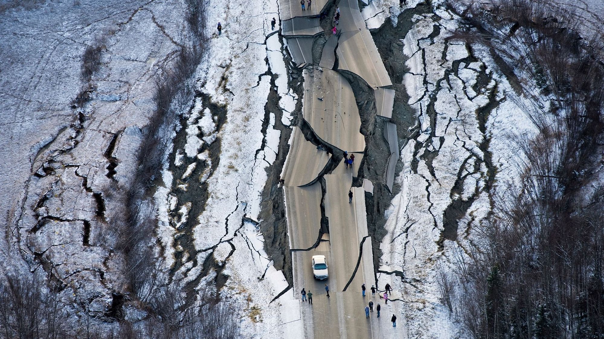 A car  trapped on a collapsed section of the off-ramp of Minnesota Drive in Anchorage, Friday, 30 November.&nbsp;