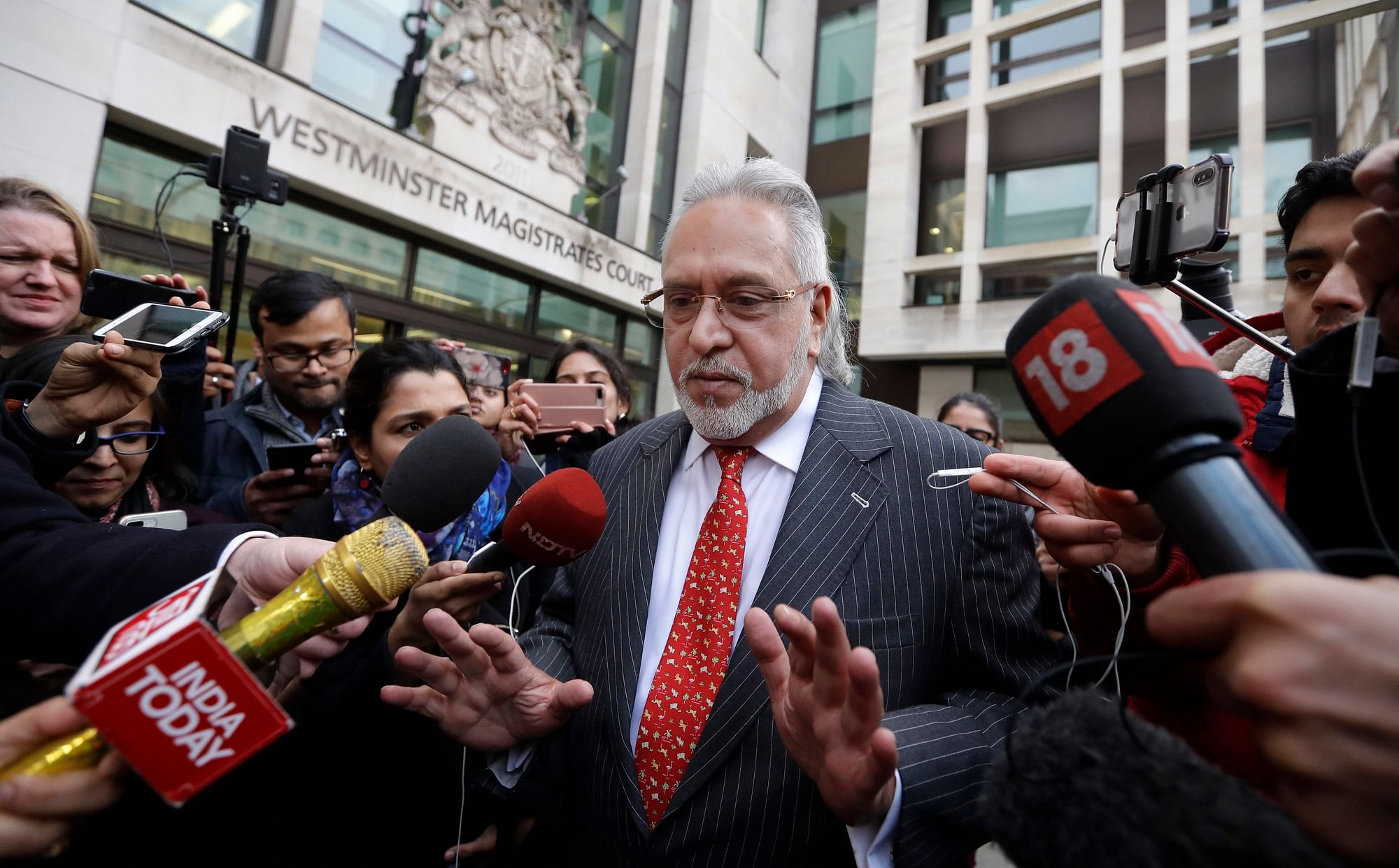 Indian businessman Vijay Mallya is surrounded by journalists as he leaves Westminster Magistrates Court in London, on 10 December 2018.