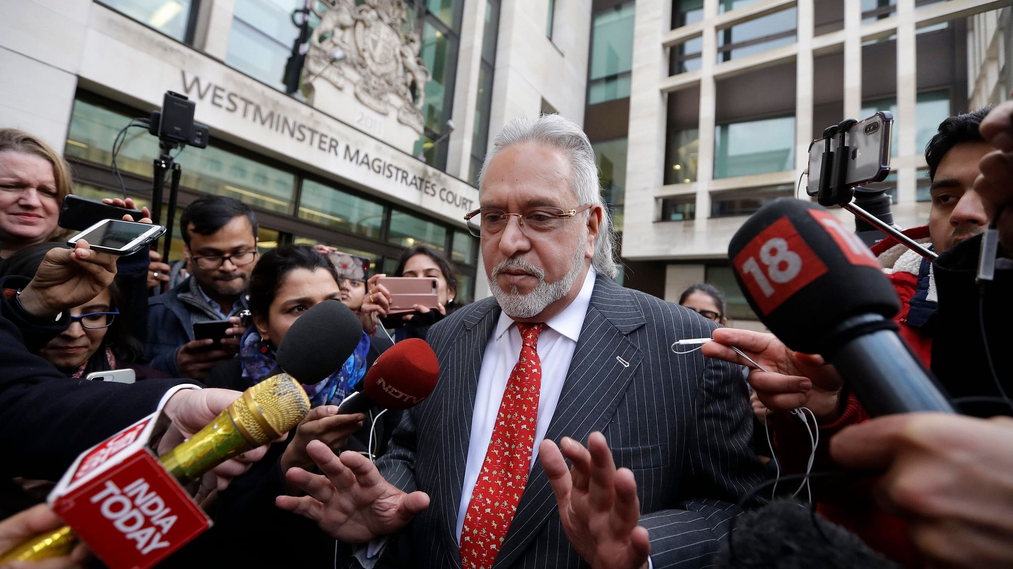 Indian businessman Vijay Mallya is surrounded by the media as he leaves Westminster Magistrates Court in London in 2018.