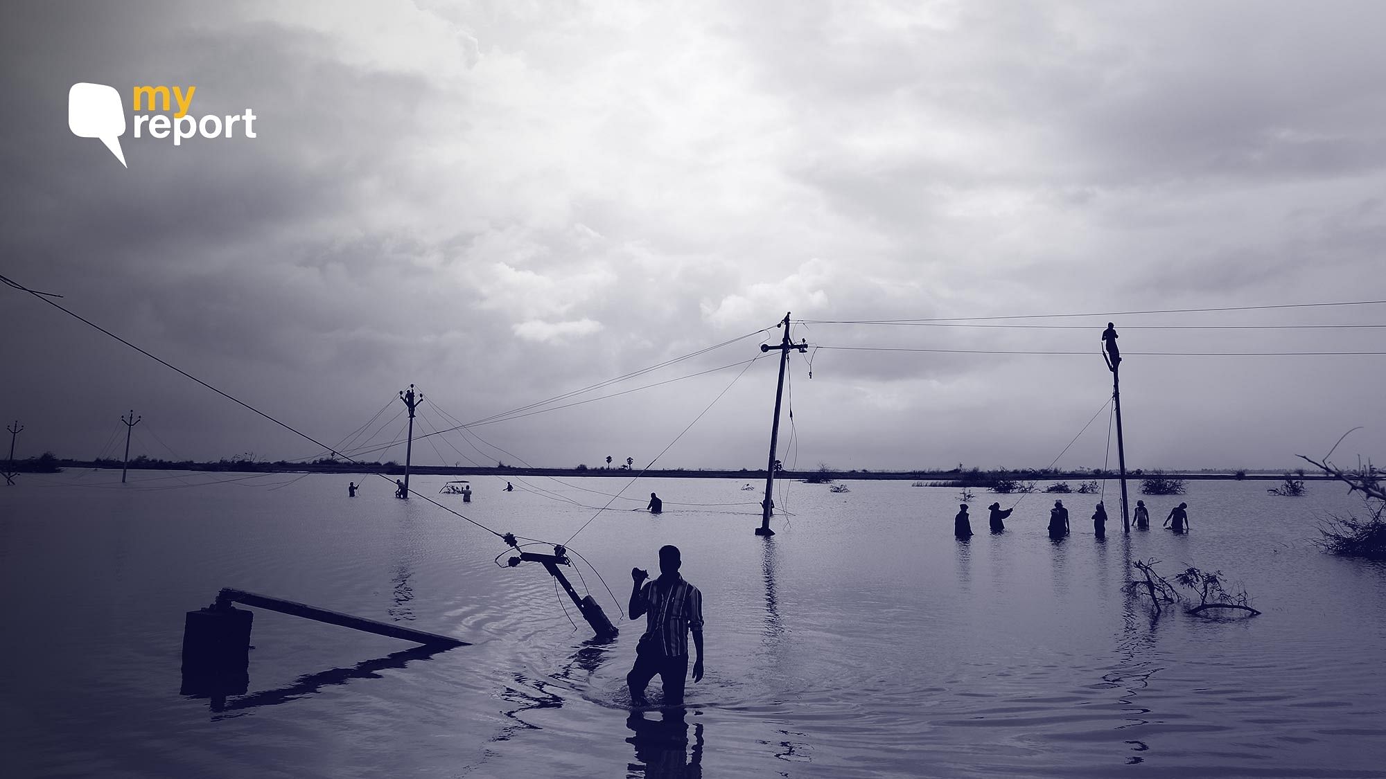 Tamil Nadu Electricity Board  workers and labourers from Andhra Pradesh involved in restoration of electrical lines in the water-logged area and shrubs near Patti Road, Vizhunthamavadi, Nagapattinam District.