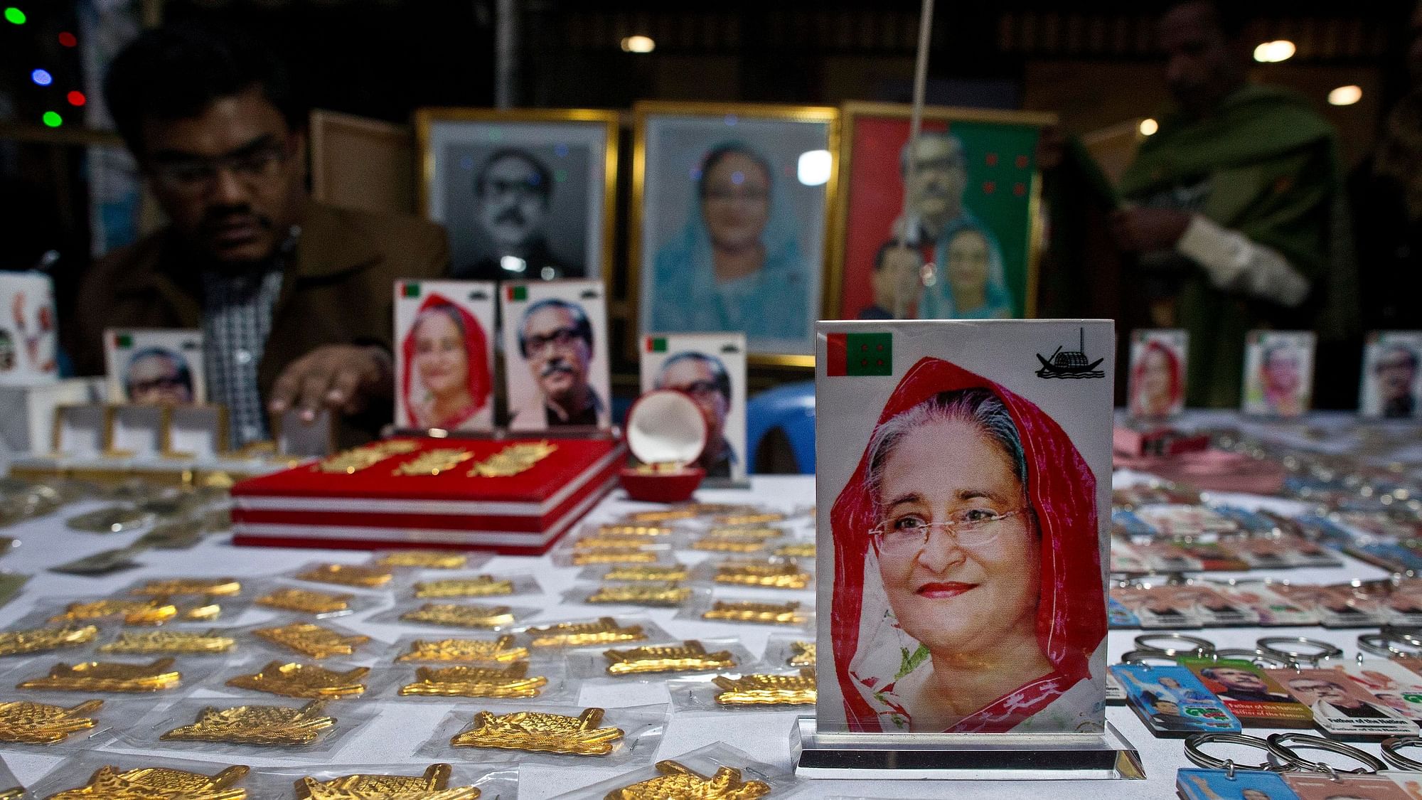 Souvenirs with pictures of Bangladesh Prime Minister Sheikh Hasina, front, and others are put up for sale at a roadside shop ahead of the general elections in Dhaka, Bangladesh.