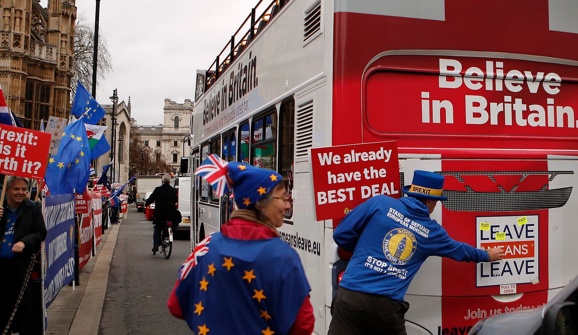 File photo of Anti Brexit demonstrators put stickers on a bus during a protest outside the Houses of Parliament in London Thursday Dec. 6, 2018.&nbsp;