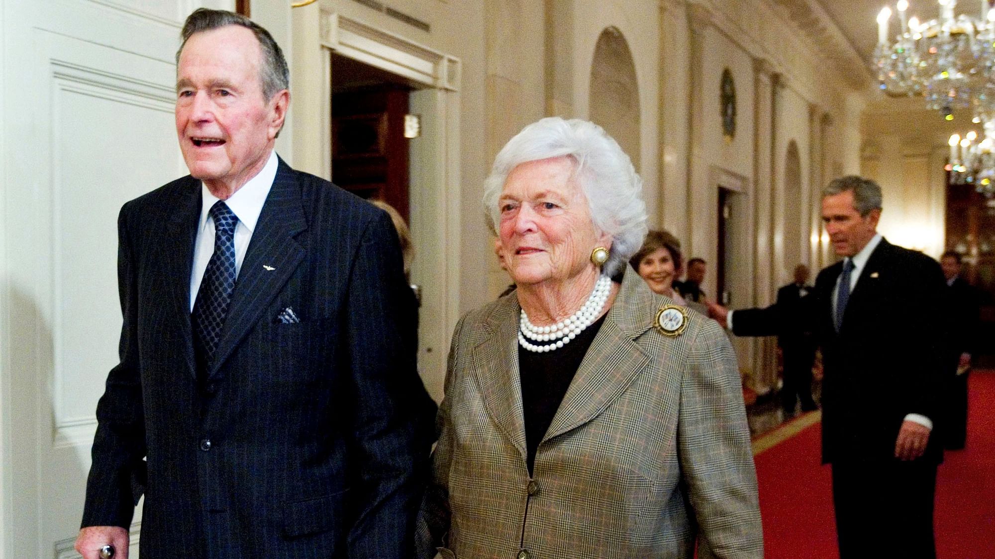 In this 2009 photo, former US President George HW Bush walks with his wife, former first lady Barbara Bush, followed by their son, President George W Bush, and his wife first lady Laura Bush, to a reception in honour of the Points of Light Institute, in the East Room at the White House in Washington.