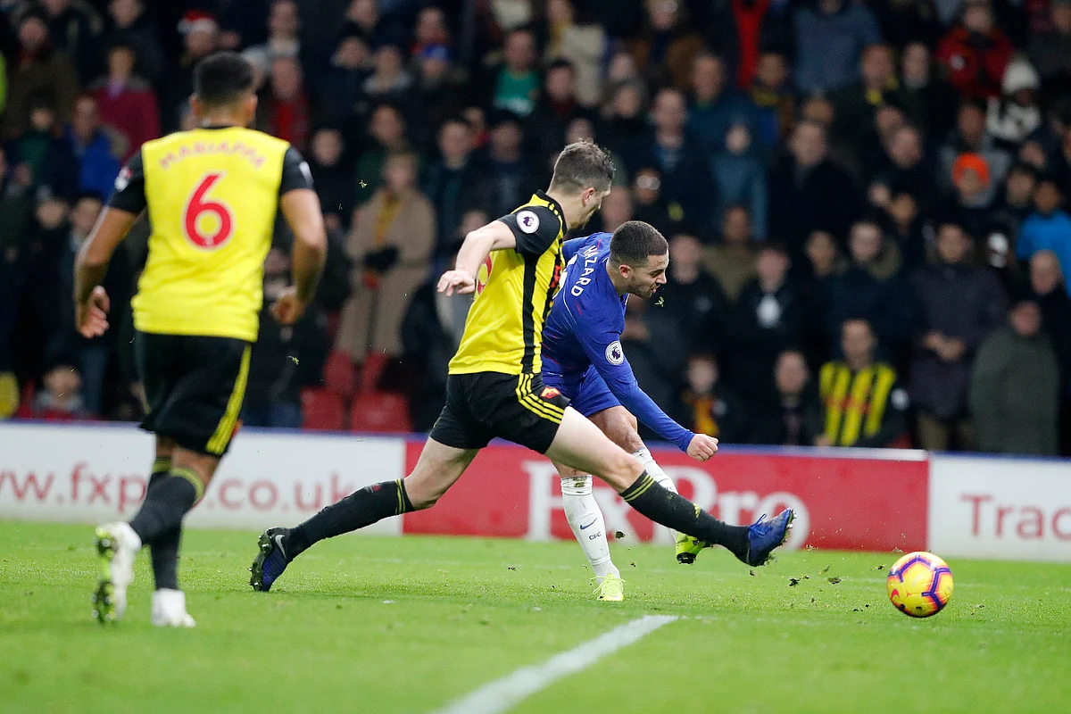 Chelsea’s Eden Hazard, back shots the ball past Watford’s Craig Cathcart, center during the English Premier League soccer match between Watford and Chelsea at Vicarage Road stadium in Watford, England on Wednesday, Dec. 26, 2018. 