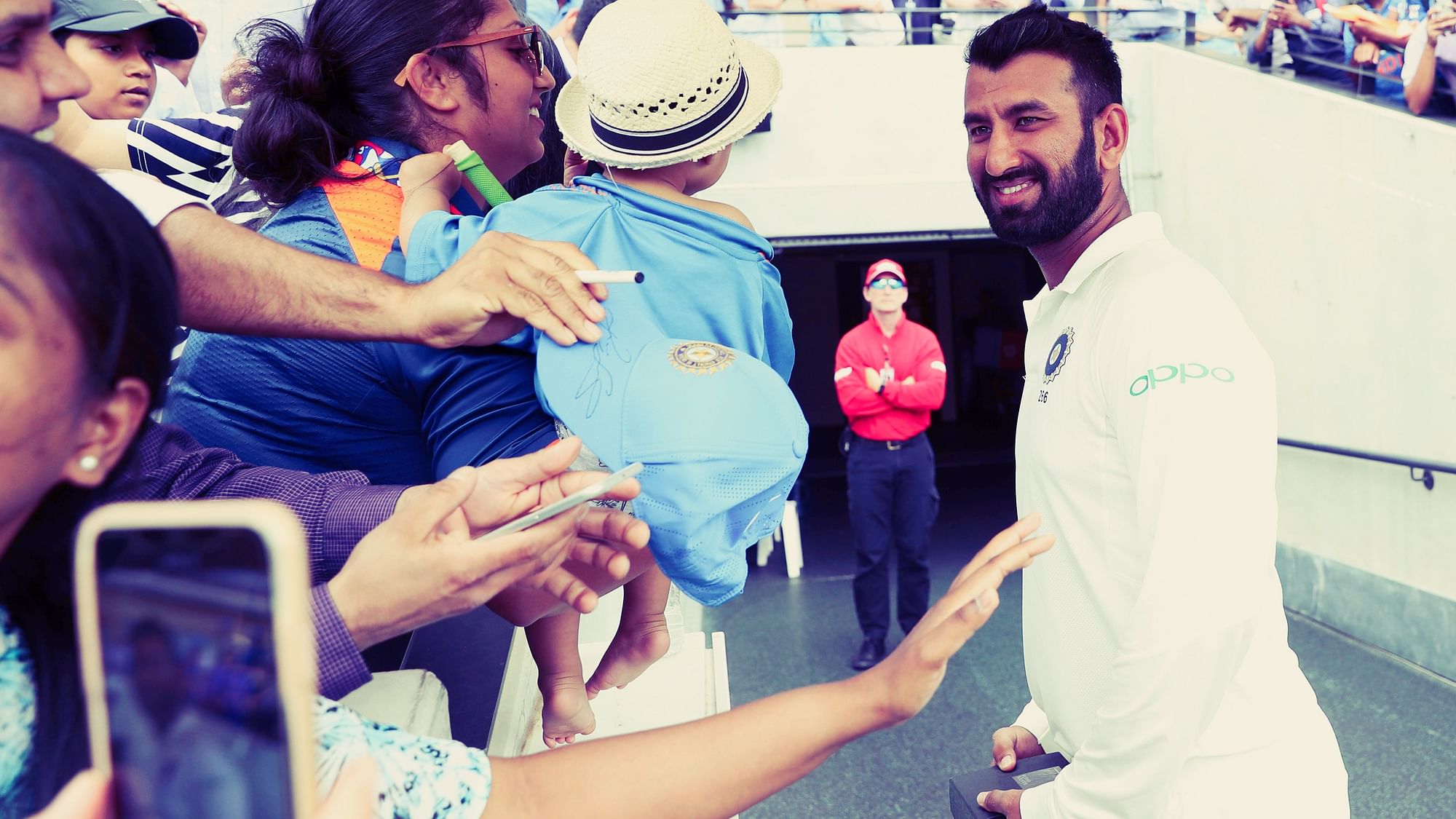 Player of the Match Cheteshwar Pujara greets fans after India’s victory over Australia at Adelaide.