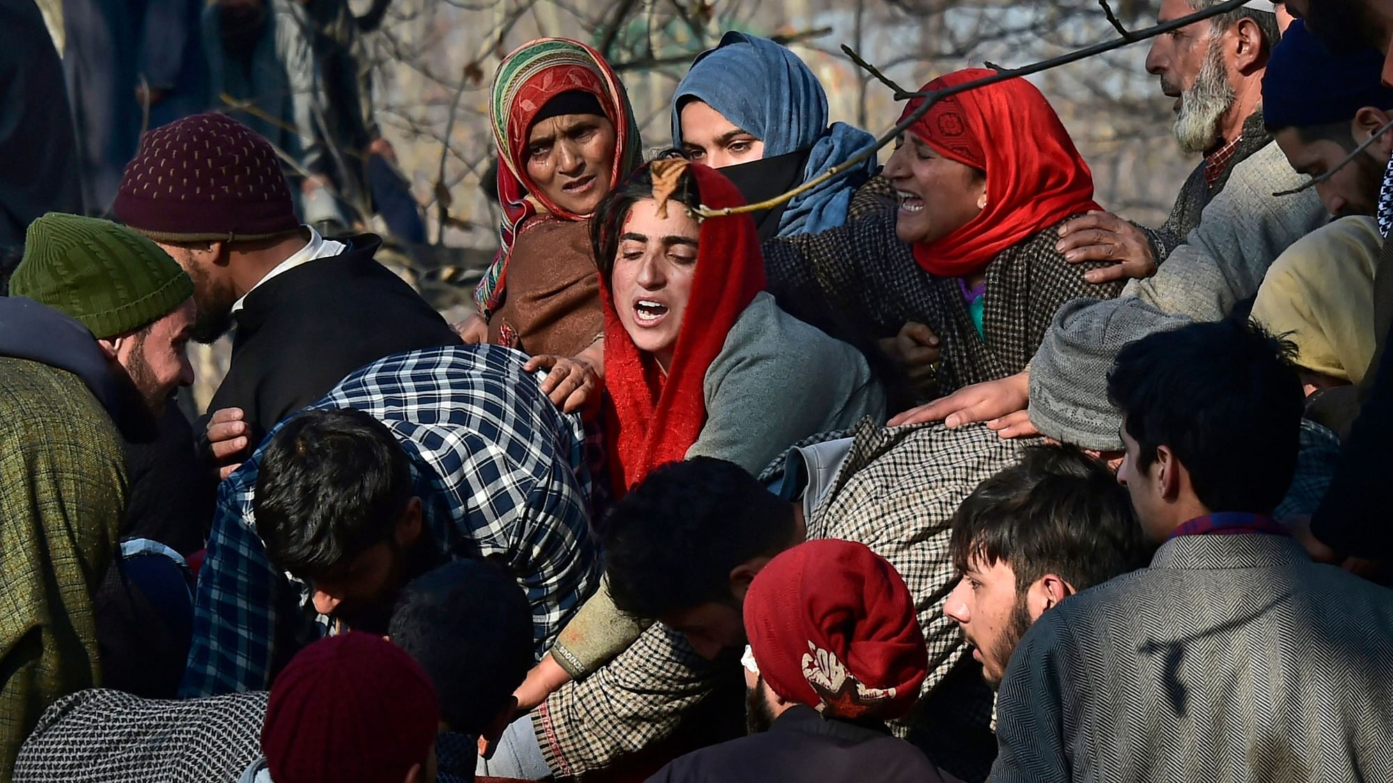Villagers wail while attending the funeral of civilians and militants who were killed in the encounter between security forces and militants, in Pulwama, south Kashmir.