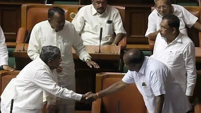 Bengaluru: Congress leader Siddaramaiah greets Karnataka Chief Minister HD Kumaraswamy at the state Assembly in Bengaluru on 25 May 2018.