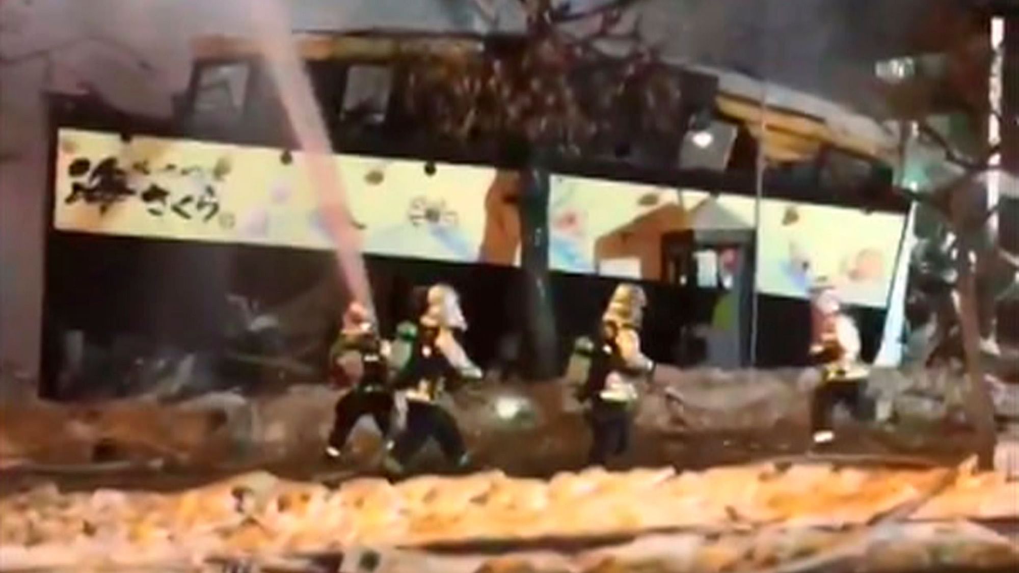 Image taken from mobile phone video where emergency workers attend the scene after an explosion.