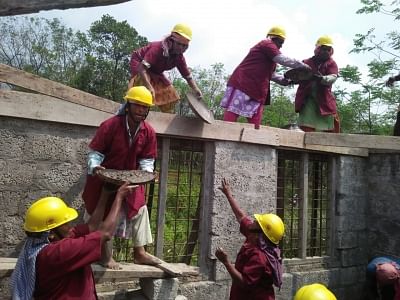 Wearing red shirts over their salwar kameez and a towel around their head, this 20-member all-women group has built their first building all by themselves.