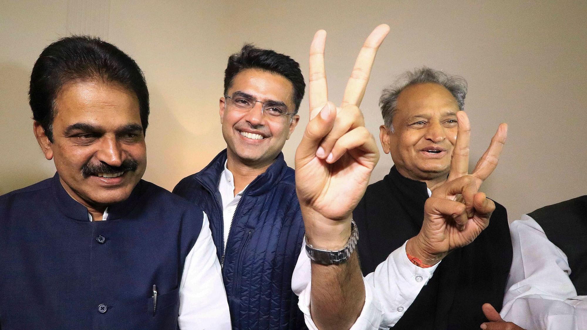 Jaipur: Congress leaders Ashok Gehlot (R) and Sachin Pilot (C) flash victory signs as KC Venugopal looks on after the declaration of Rajasthan Assembly election result, in Jaipur, Tuesday, 11 December 2018.