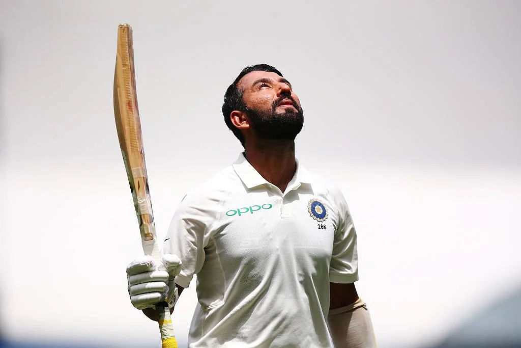 Cheteshwar Pujara celebrates after reaching his 17th Test hundred on Day 2 of the Boxing Day Test at MCG.
