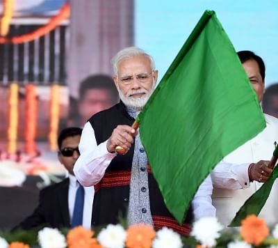 Dibrugarh: Prime Minister Narendra Modi flags off the first passenger train passing through the Bogibeel Bridge, at Dibrugarh, Assam on Dec 25, 2018. (Photo: IANS/PIB)